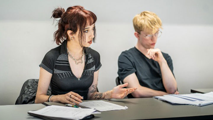 Two students discussing their work.