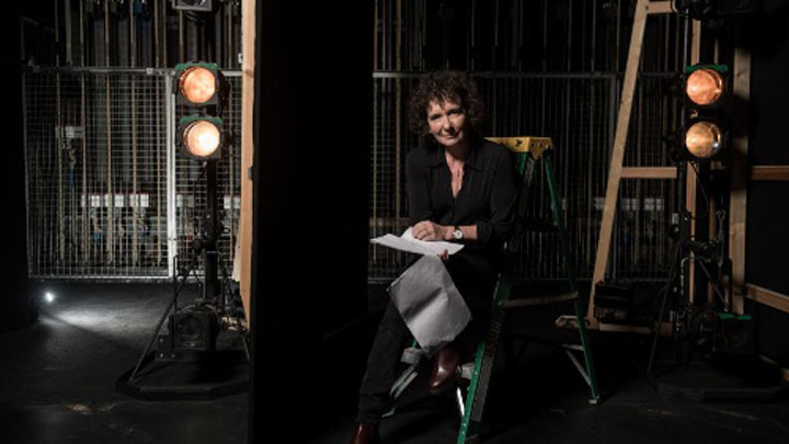 Jeanette Winterson sitting with a script backstage.